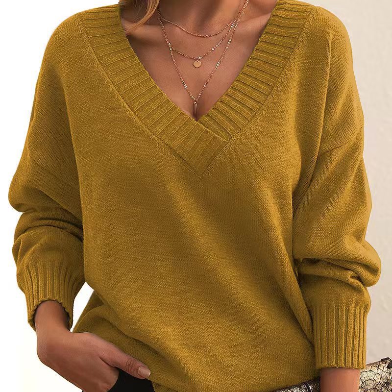Mustard yellow sweater worn by a person on a white background