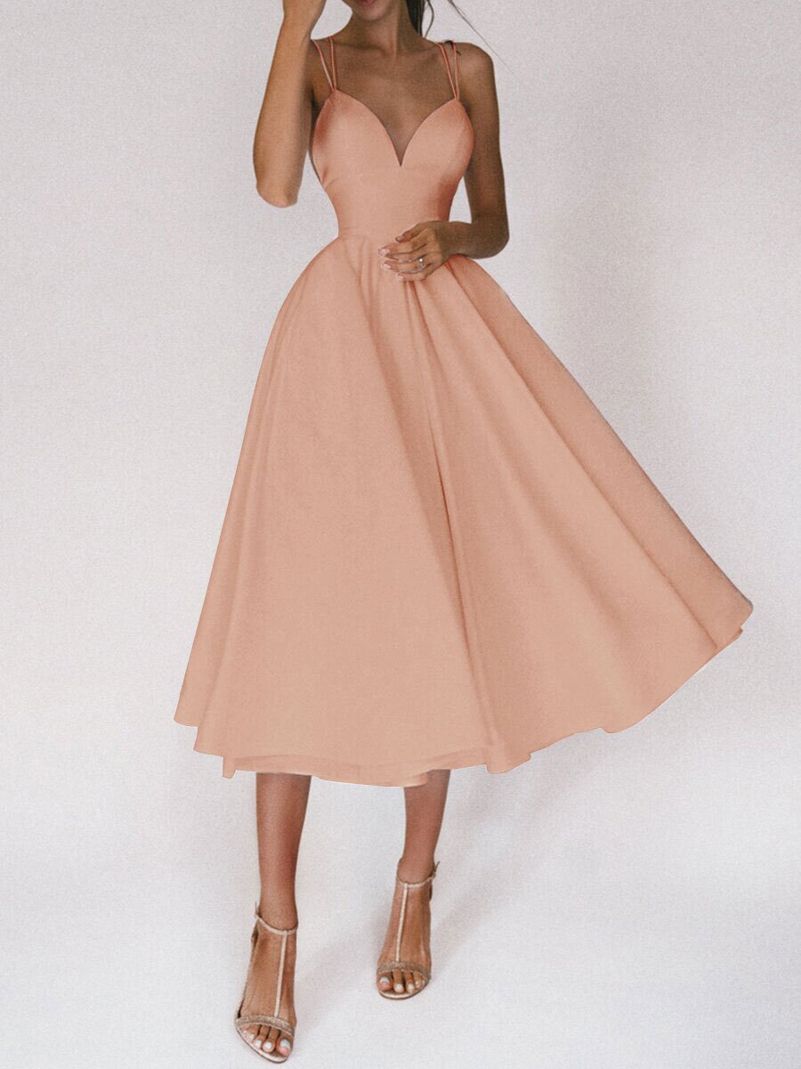 Woman wearing a beige dress on a white background