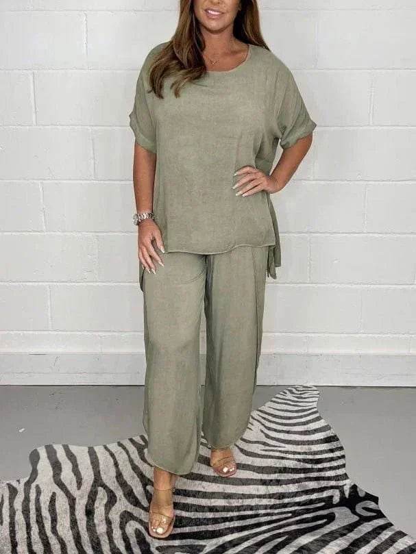 Woman modeling sage green loungewear set from ZA-Zola on zebra print rug