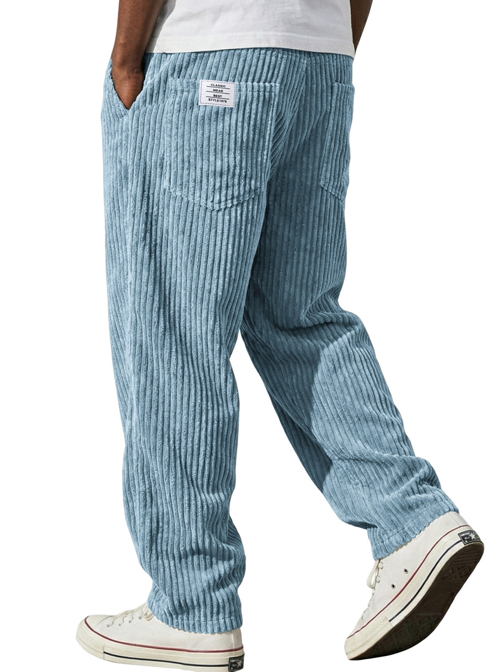 Light blue corduroy pants worn by a person on a white background