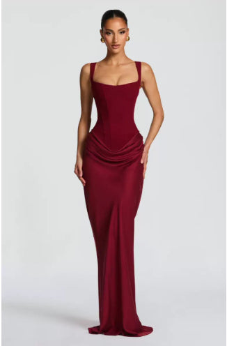 Woman wearing a burgundy evening gown on a white background