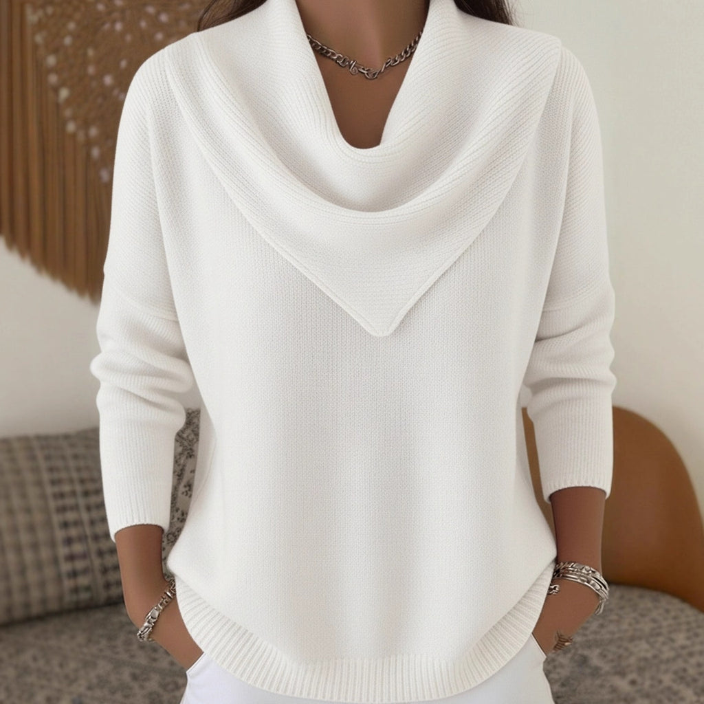 White sweater worn by a person with a blurred background