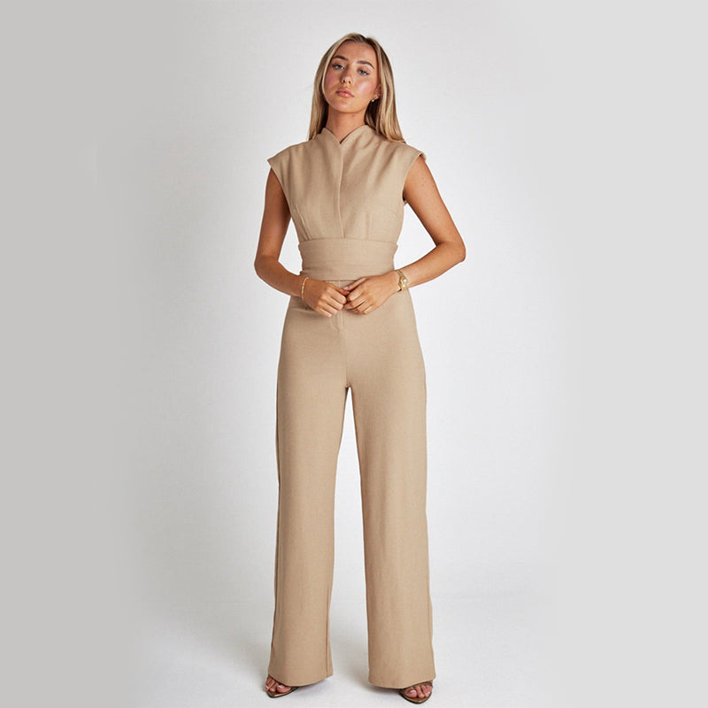 Woman wearing a beige jumpsuit on a white background
