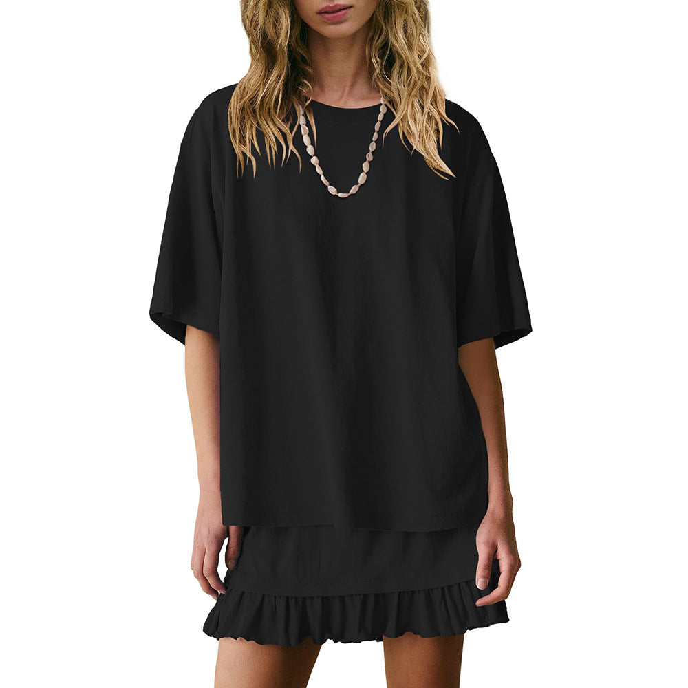Black dress with ruffled hem worn by a model on a white background