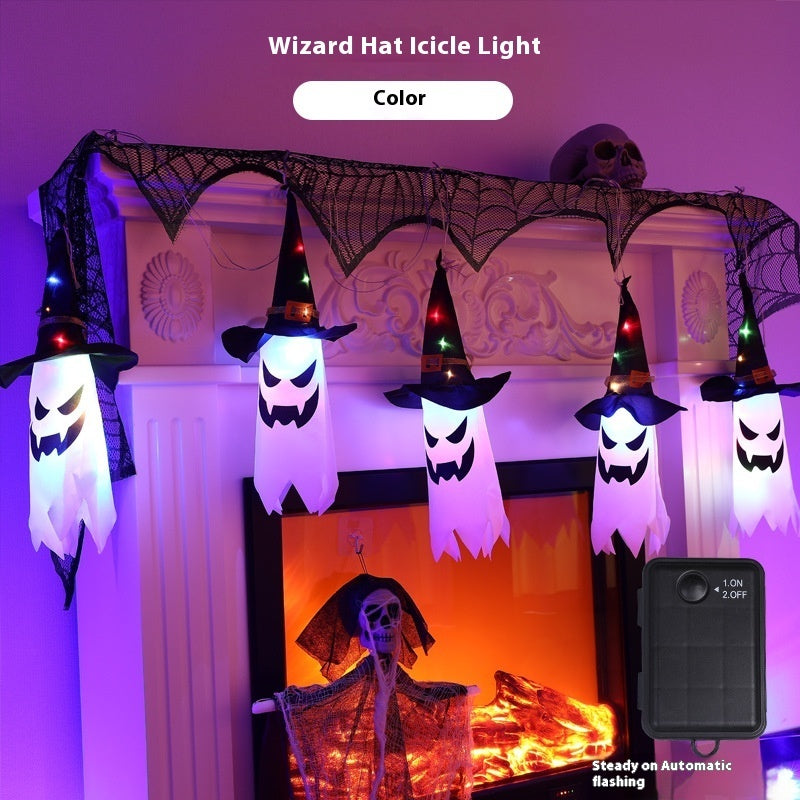 Halloween-themed decoration with ghost figures in witch hats and a skeleton, illuminated by Wizard Hat Icicle Lights.