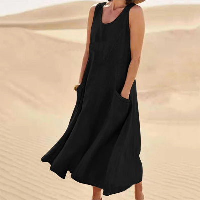 Person wearing a black sleeveless dress in a desert setting
