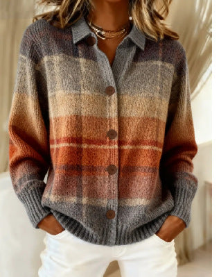 A woman wearing a fuzzy knit button-front cardigan with a plaid pattern in gray, rust orange, beige, and brown tones, paired with white pants.