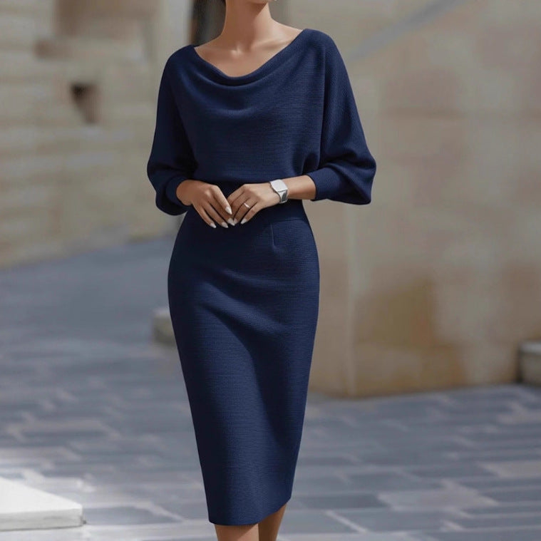 Navy blue dress worn by a person with a blurred background