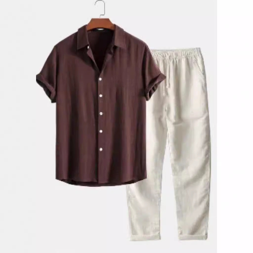 Brown shirt and beige pants on hangers against a white background