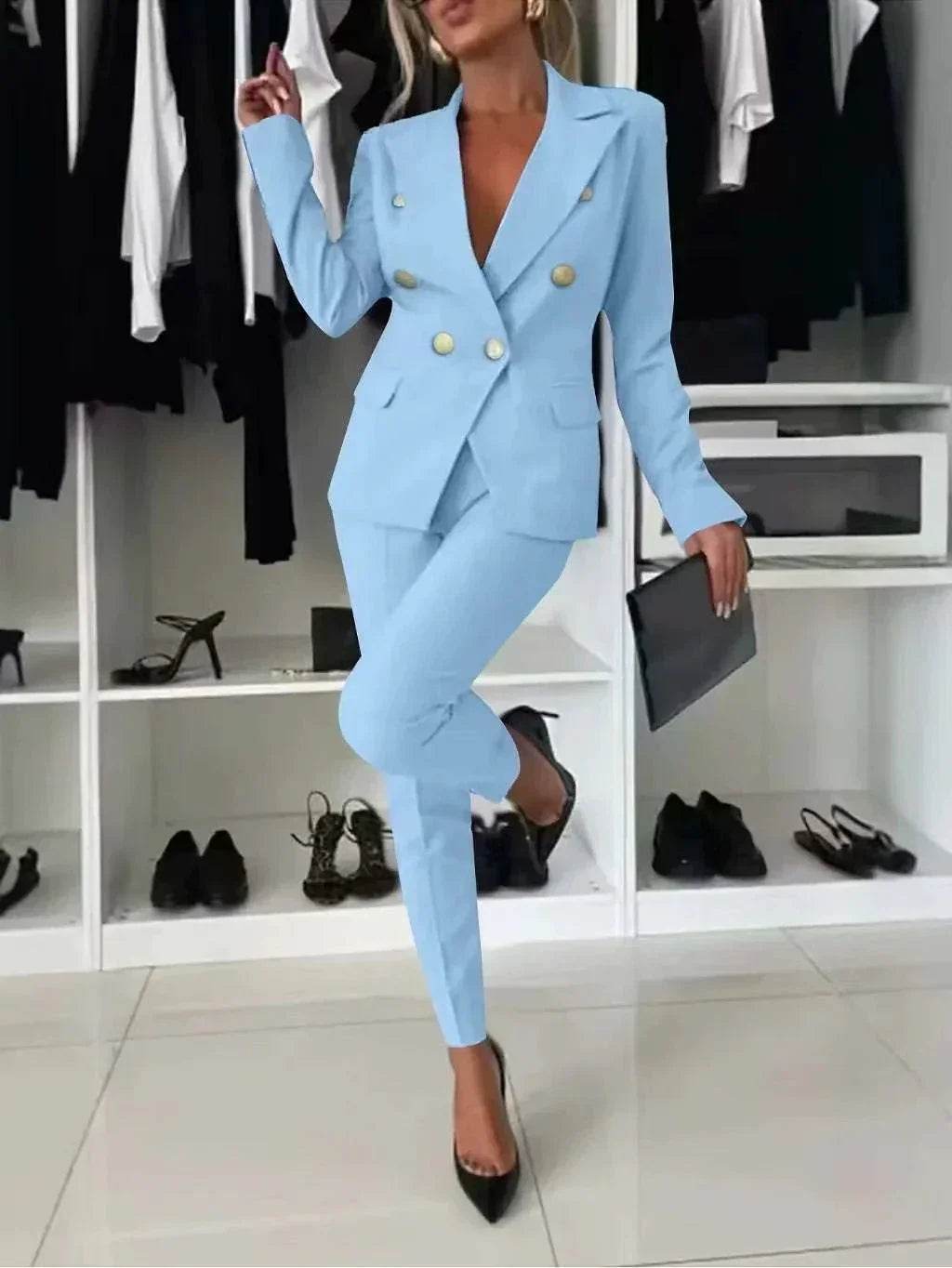 Woman in chic light blue pantsuit with gold buttons, black heels, clutch in closet, ZA-Zola fashion
