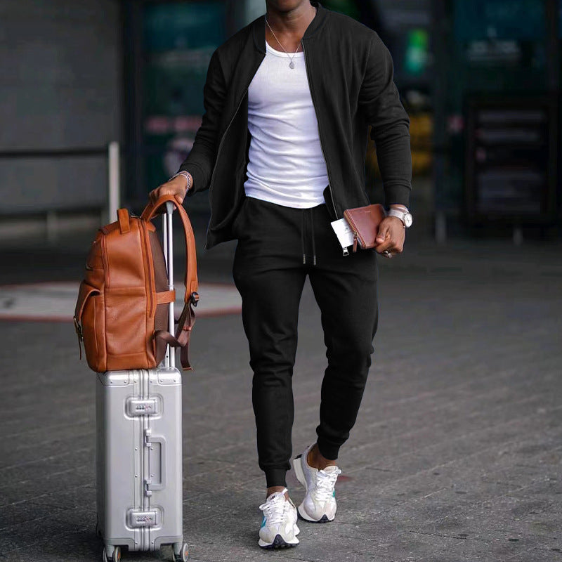 Person walking with a suitcase and backpack in an urban setting