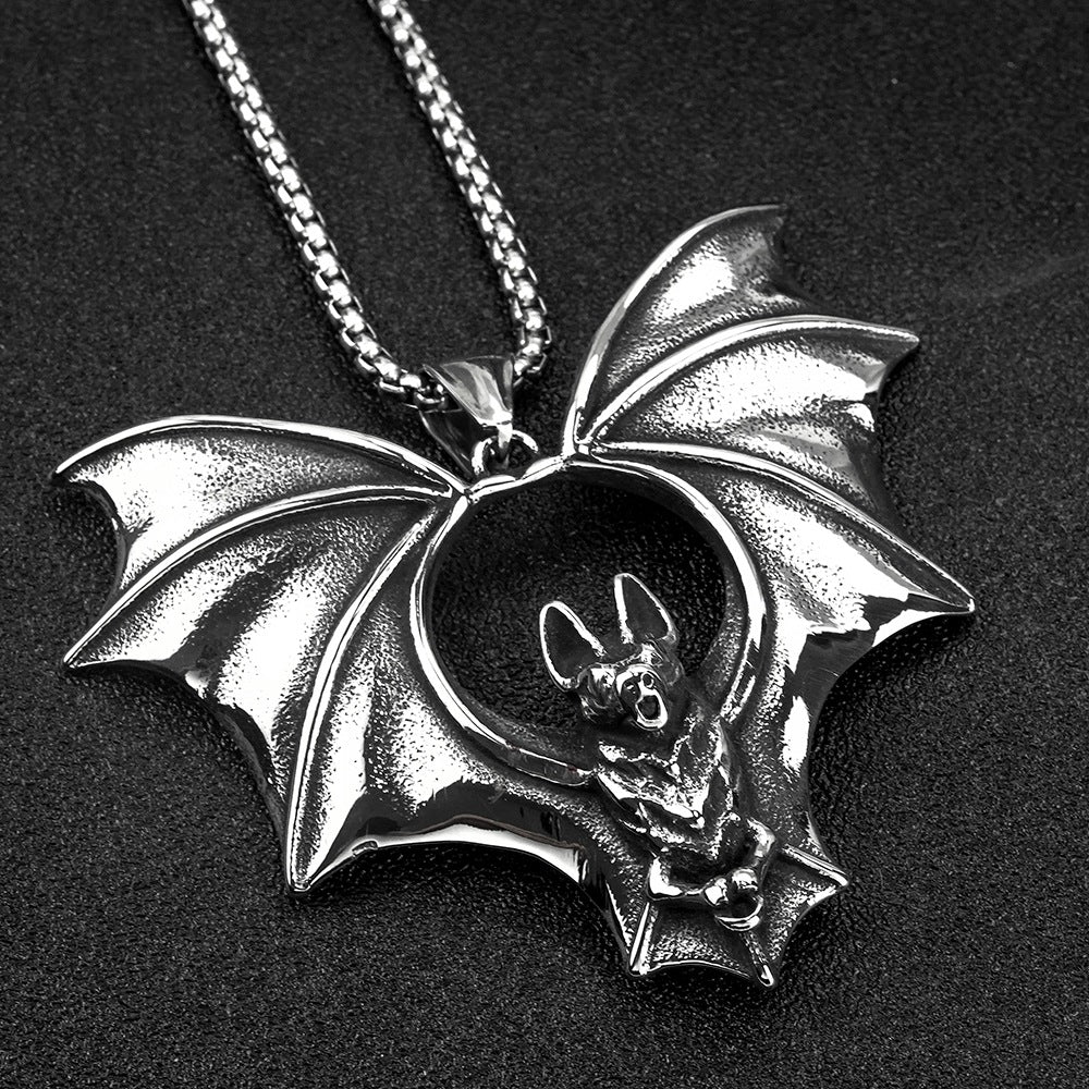Silver bat pendant necklace on a black background