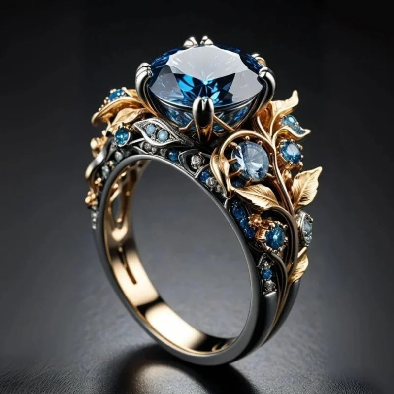 Elaborate ring with blue gemstone and gold accents on a dark background