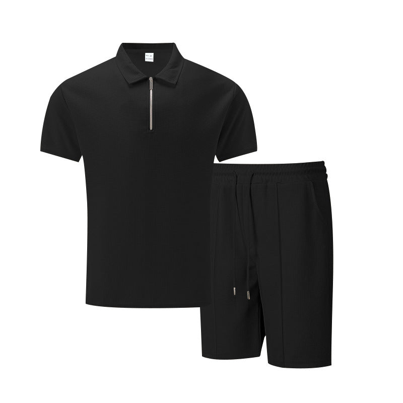 Black polo shirt and shorts set on a white background