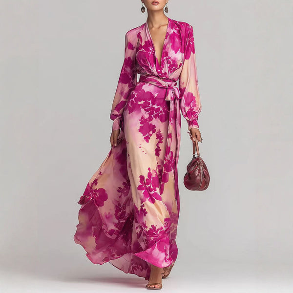 Woman wearing a pink floral dress holding a matching handbag against a gray background