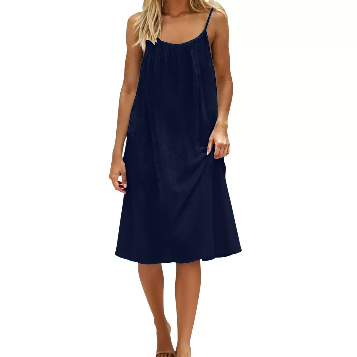 Navy blue slip dress worn by a model on a white background