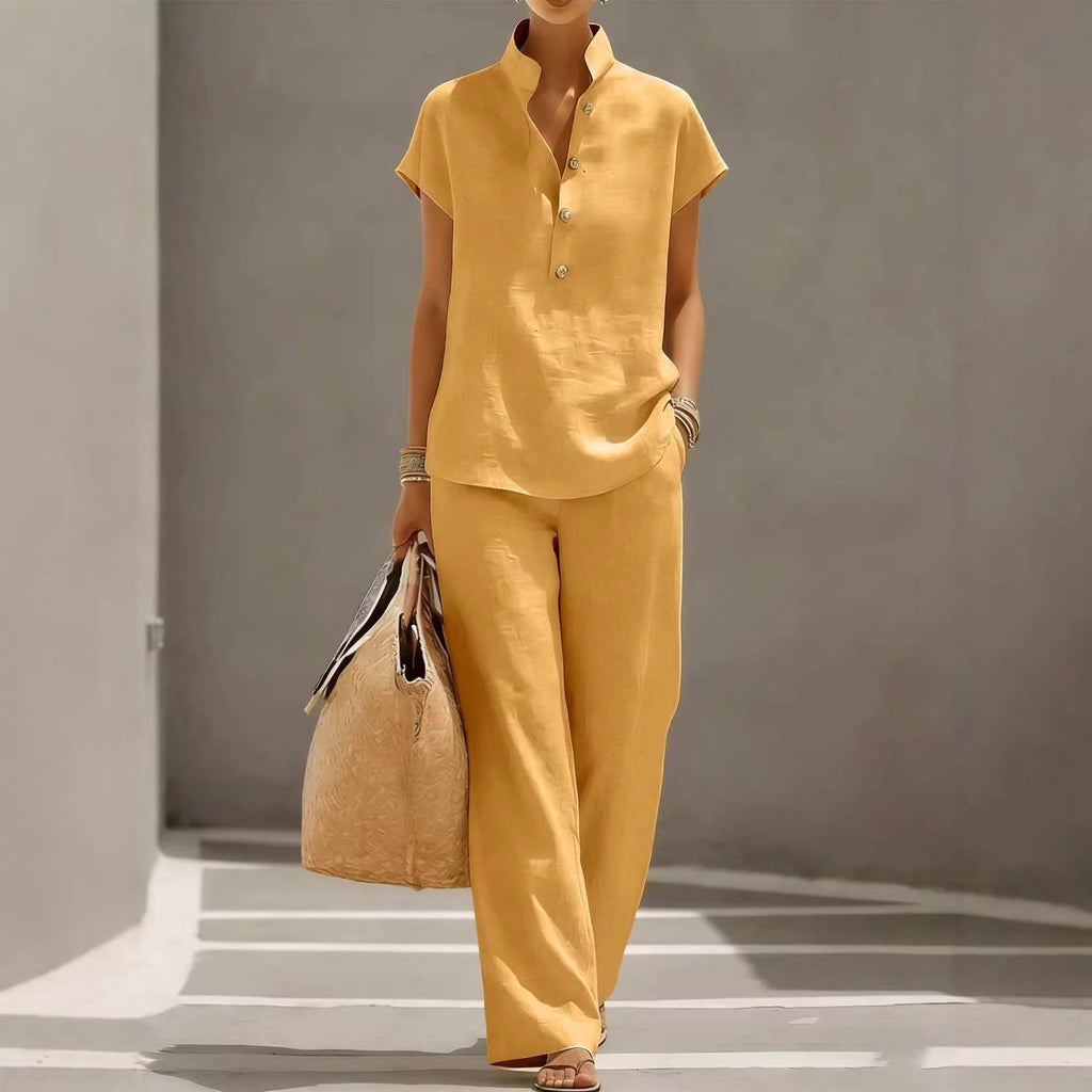 Person wearing a yellow outfit holding a bag against a gray background