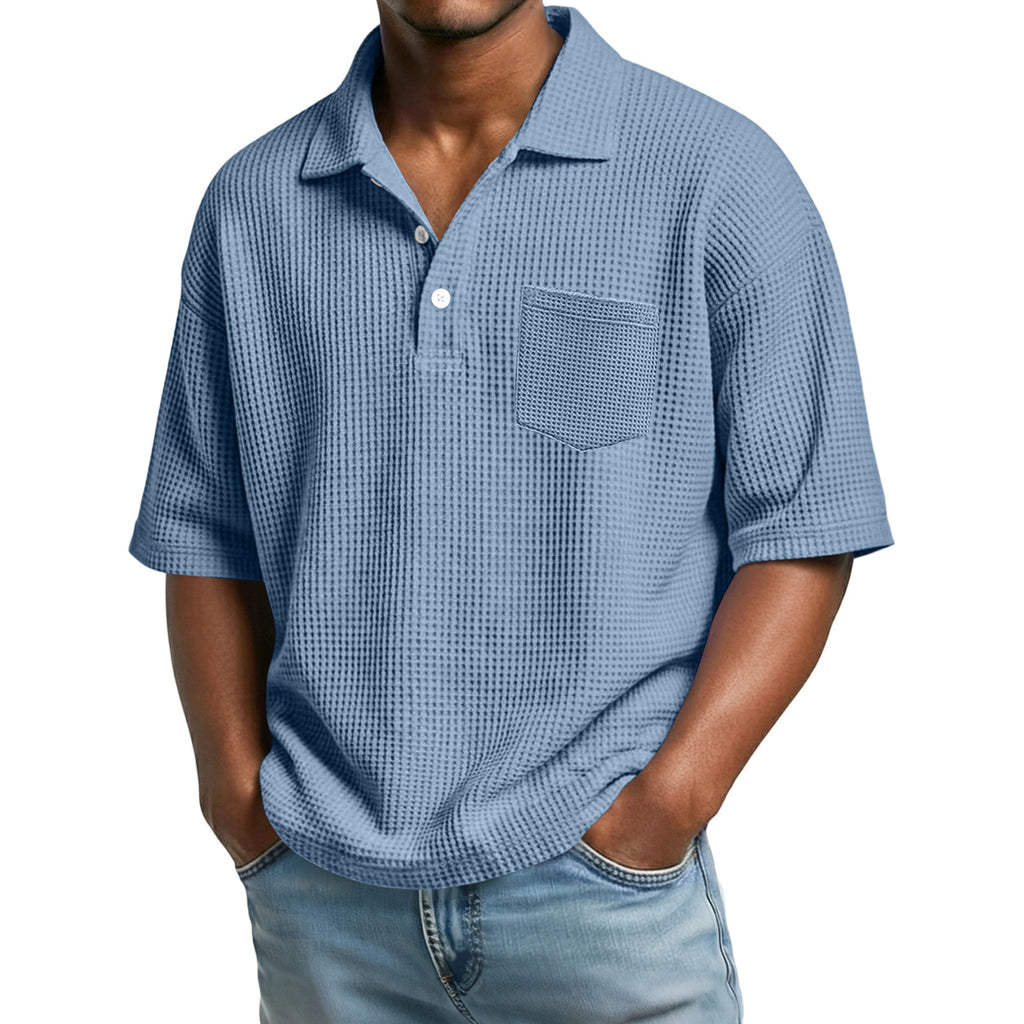 Man wearing a blue checkered shirt with a pocket on a white background
