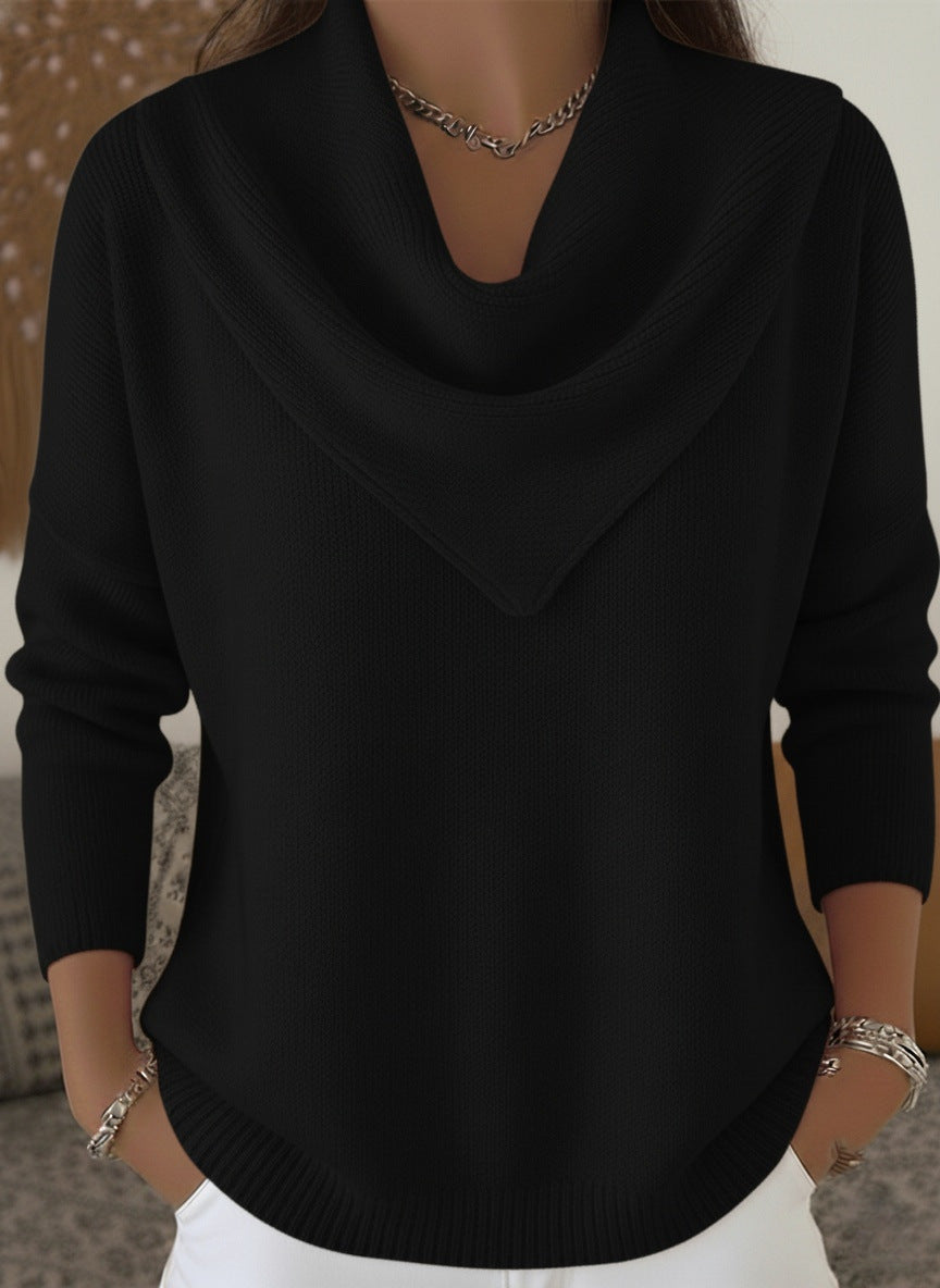 Black sweater worn by a person with a neutral background