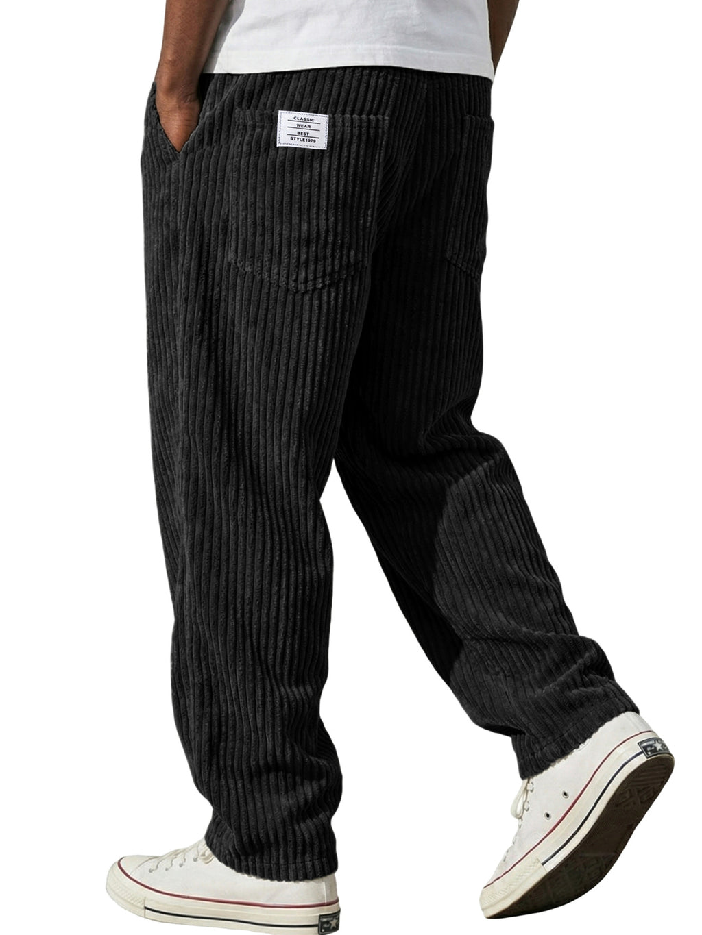Black striped pants worn by a person on a white background