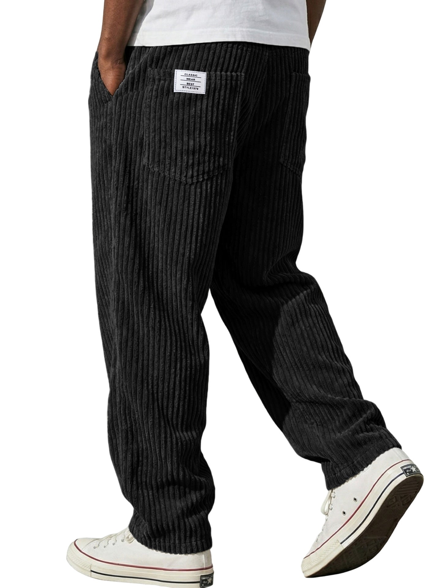 Black striped pants worn by a person on a white background