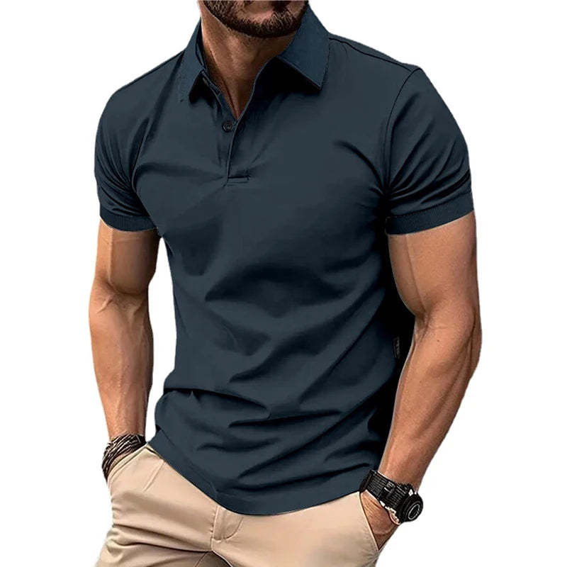 Man wearing a dark blue polo shirt and beige pants on a white background
