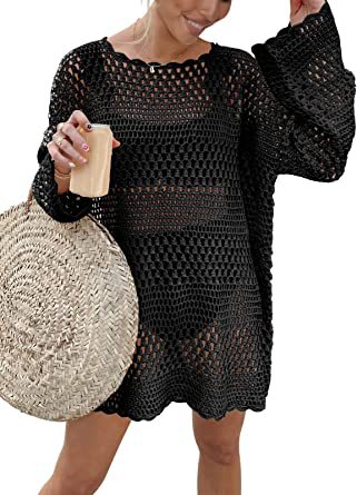 Woman wearing a black crochet dress holding a beige bag.