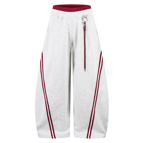 White wide-leg pants with red accents on a white background