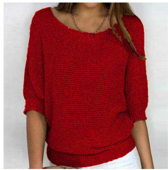 Red knitted sweater worn by a person on a white background