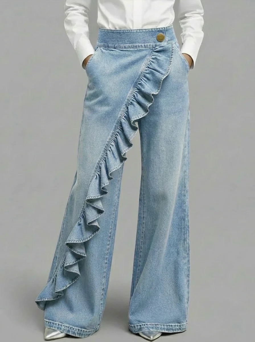 Light blue denim pants with ruffles on a gray background