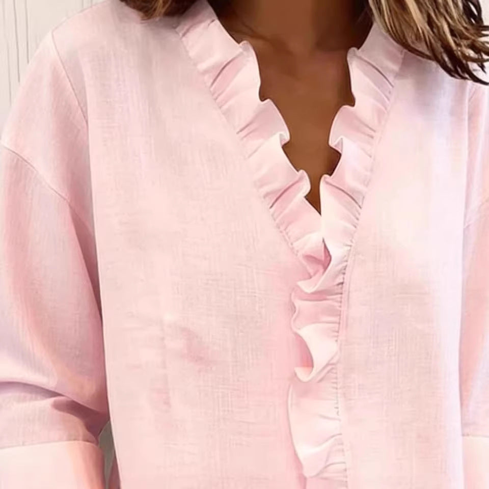 Close-up of a pink blouse with ruffled details
