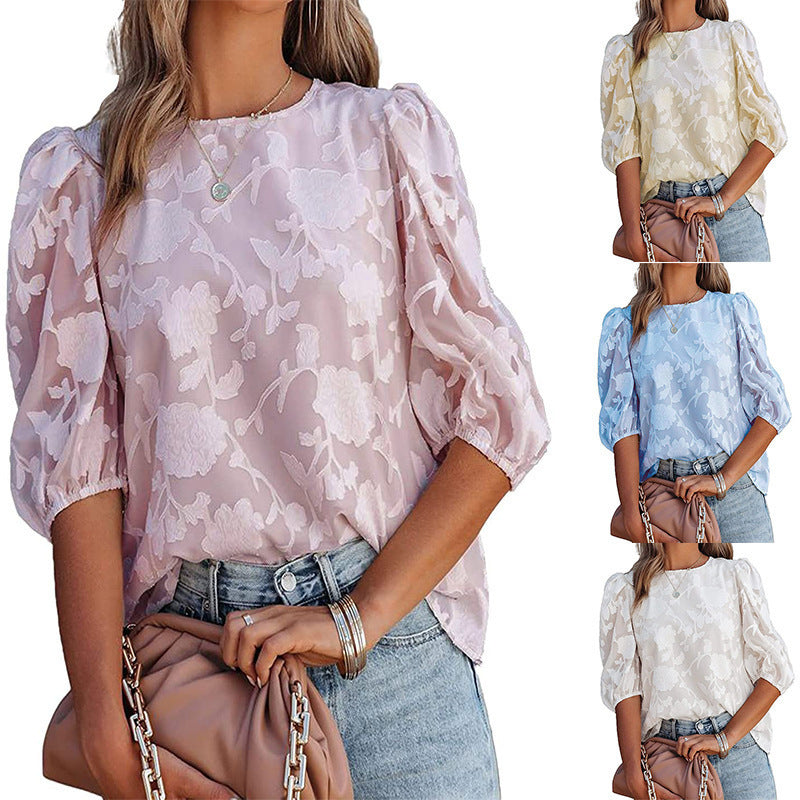 Woman wearing a floral blouse with puffed sleeves in various color options.