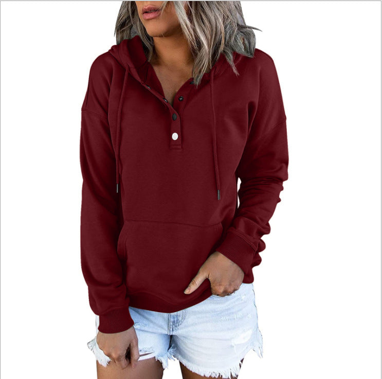 Maroon hoodie worn by a person on a white background