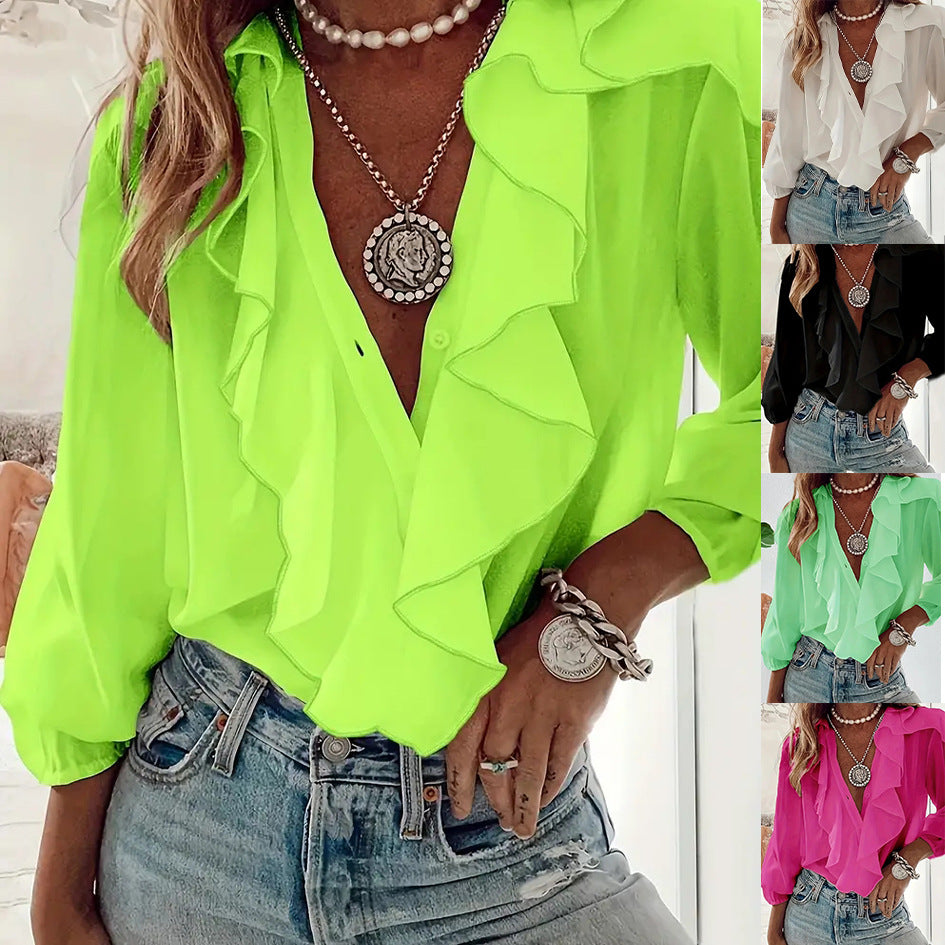 Person wearing a bright green blouse with ruffled details, denim shorts, and layered necklaces.