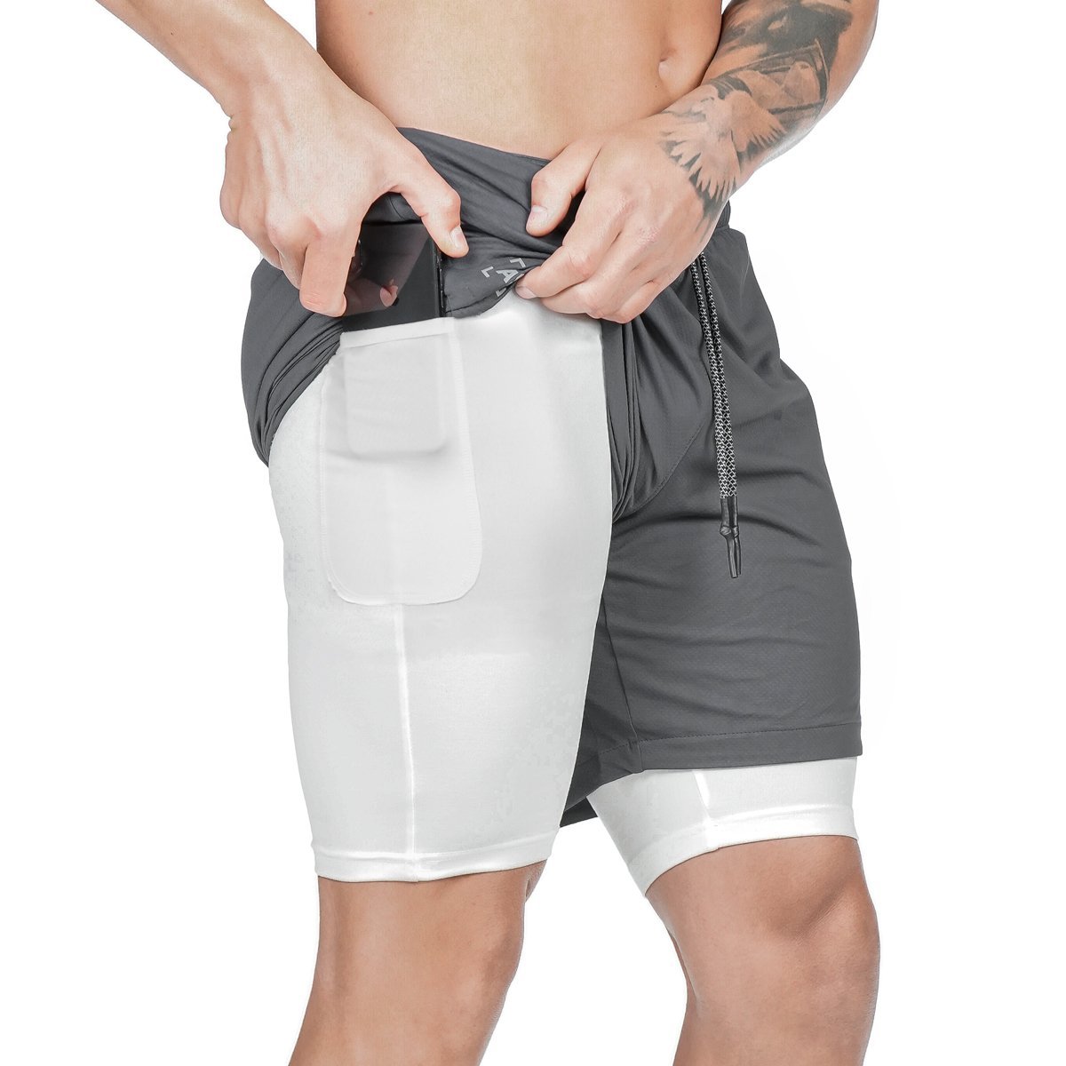 Person wearing gray and white athletic shorts on a white background