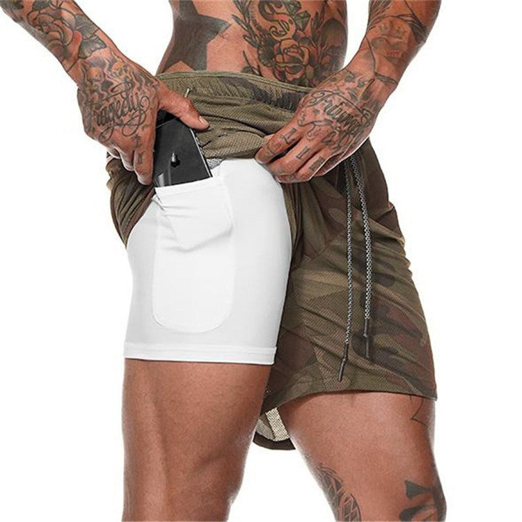 Person wearing a green duster over white shorts on a plain background