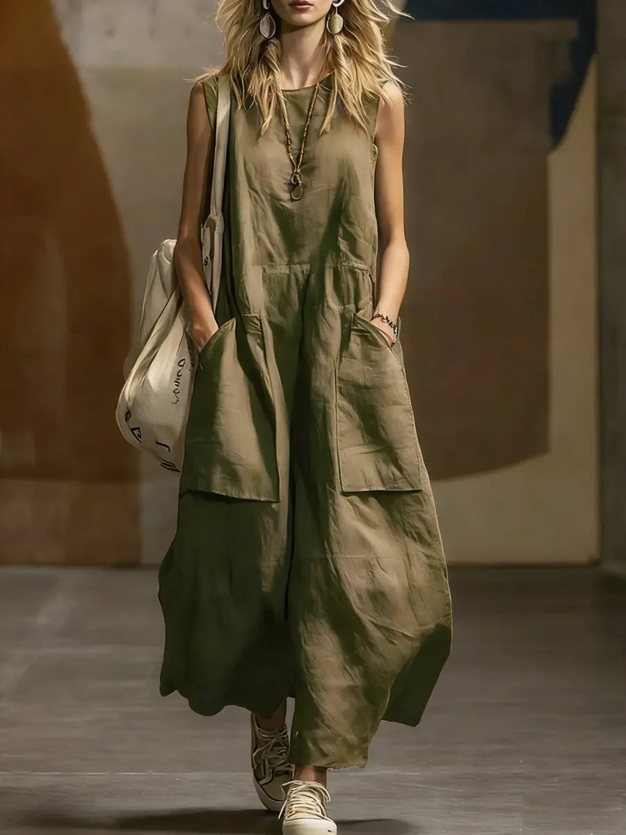 Woman wearing a green sleeveless jumpsuit with a neutral background
