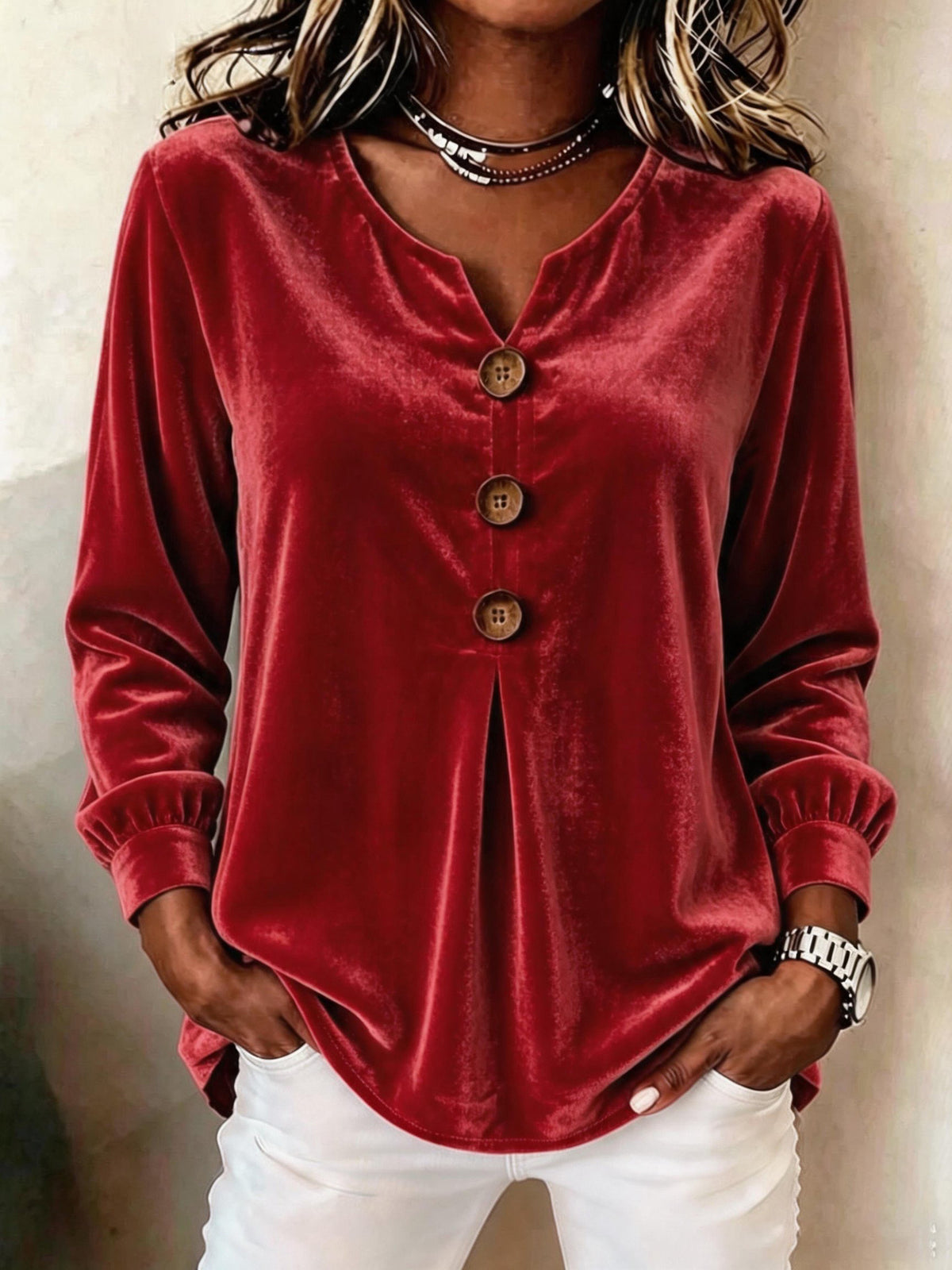 Red velvet long-sleeve top worn by a person with a neutral background