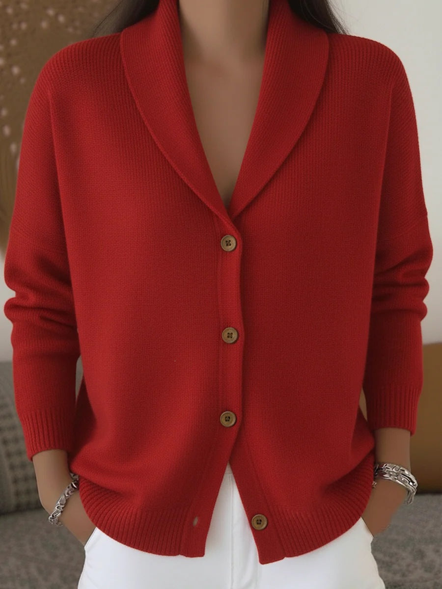 Red cardigan worn by a person with a neutral background