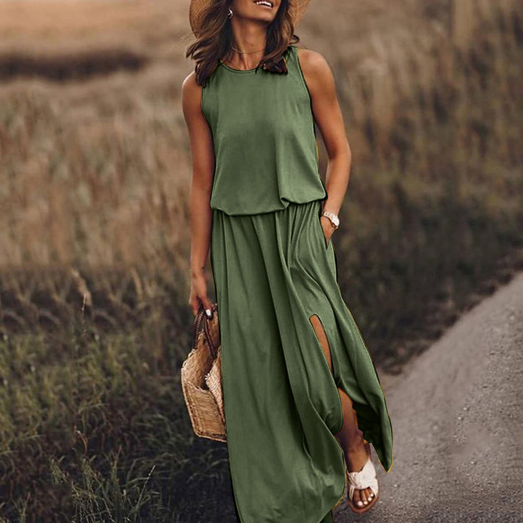 Woman in a green dress standing on a road with a field in the background