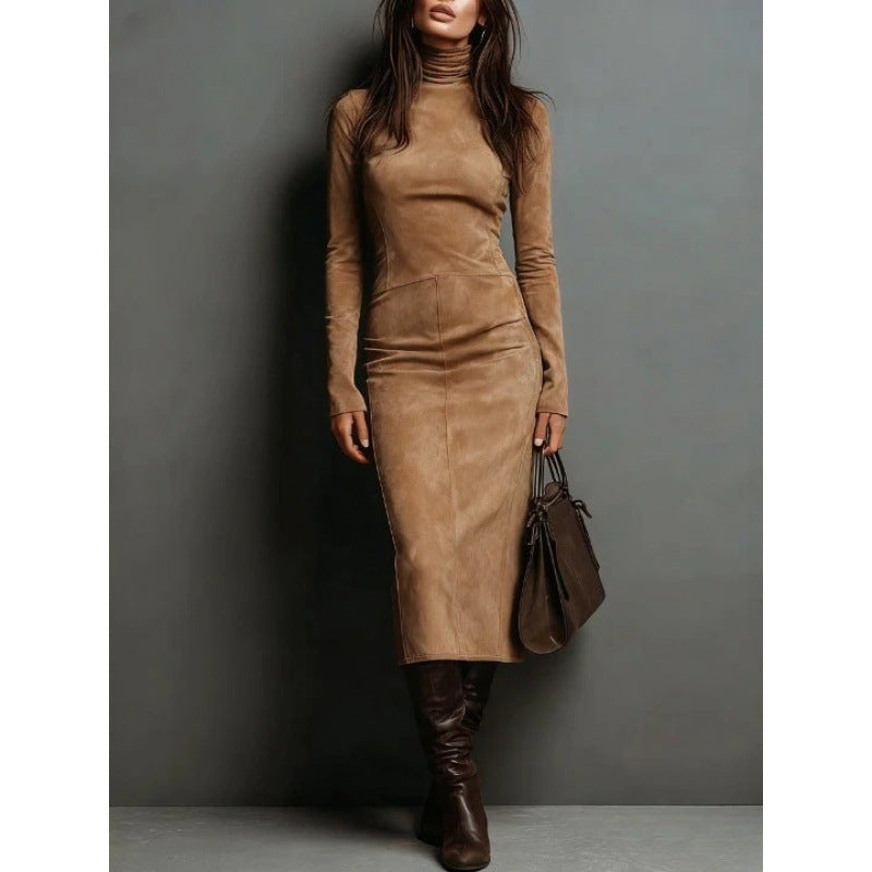 Woman wearing a brown suede dress and boots against a gray background