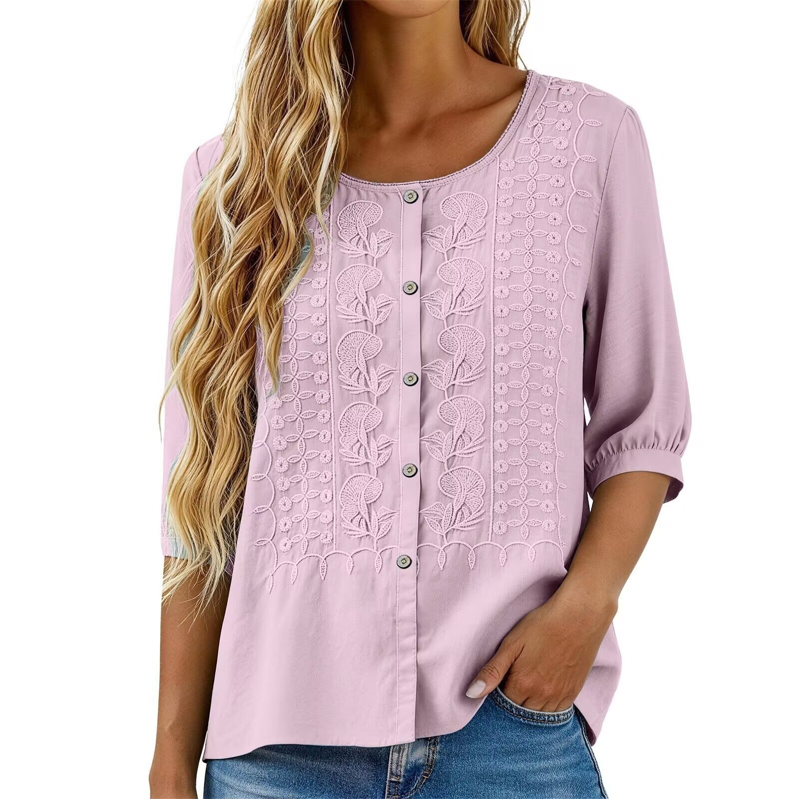 Light pink blouse with floral embroidery on a white background