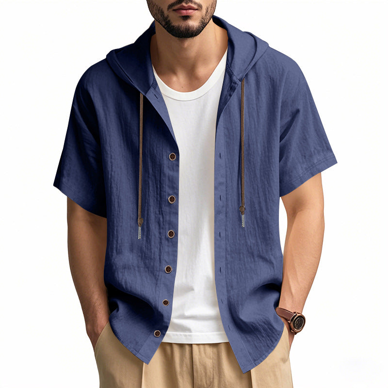 Man wearing a blue short-sleeve hooded shirt over a white t-shirt on a white background