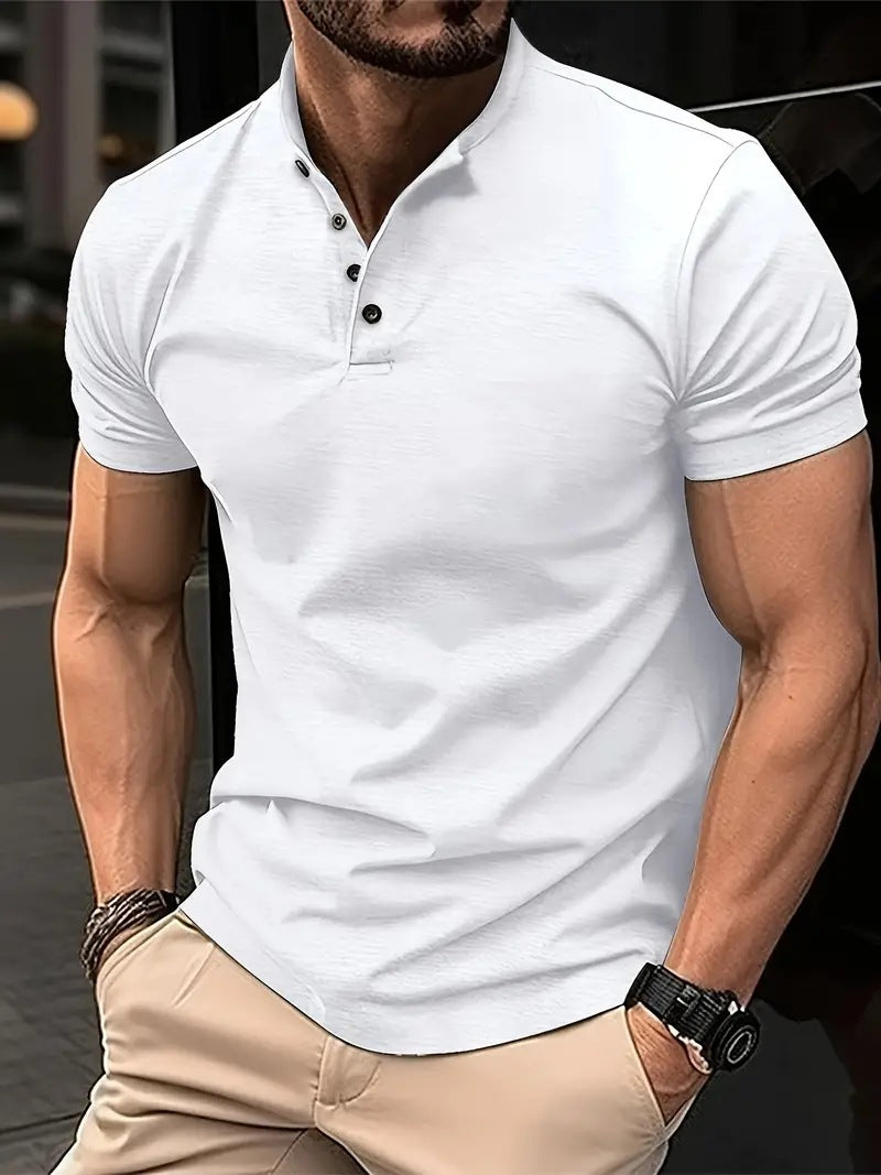 Man wearing a white polo shirt and beige pants with a blurred background