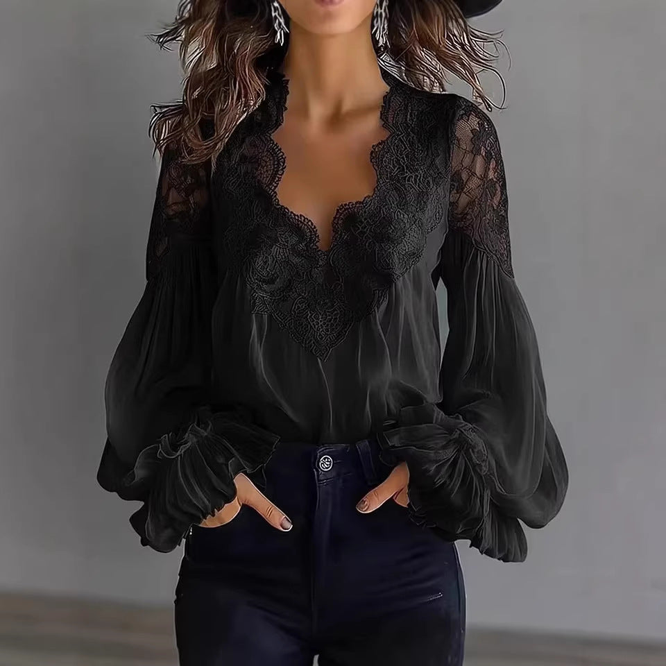 Black lace blouse with puffed sleeves worn by a person against a neutral background