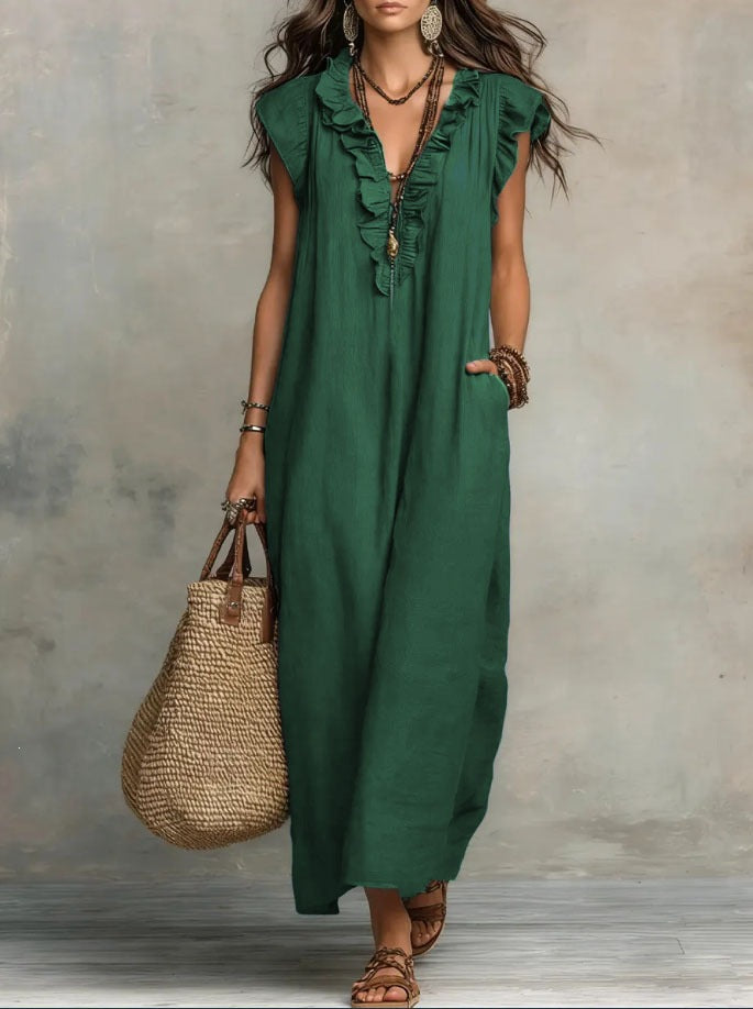 Woman wearing a green dress holding a straw bag against a neutral background