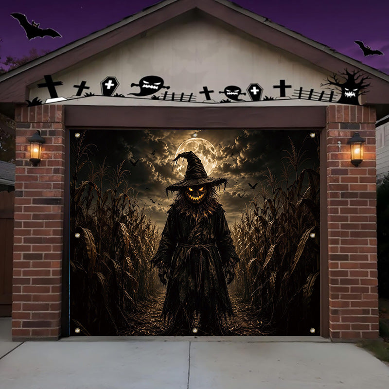 A Halloween-themed garage door mural featuring a scary witch figure in a cornfield under a full moon, shown installed on a residential garage with brick pillars and lit wall sconces.