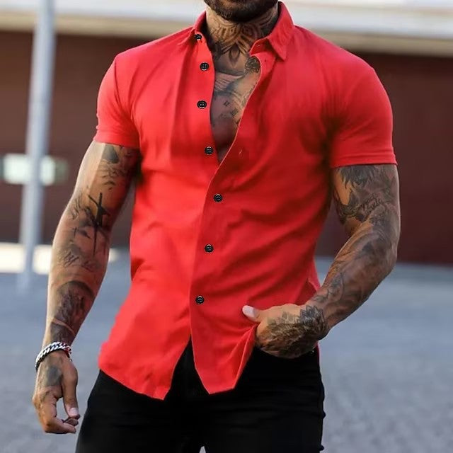 Man wearing a red button-up shirt with tattoos on arms and chest.
