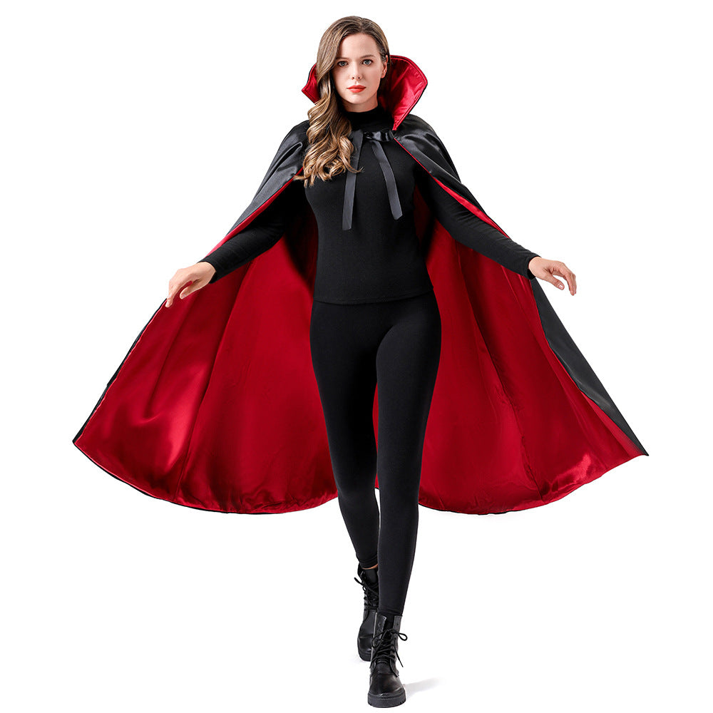 A woman modeling a vampire-style costume cape with a black outer fabric and a deep red satin lining, worn over a black outfit against a plain white background.