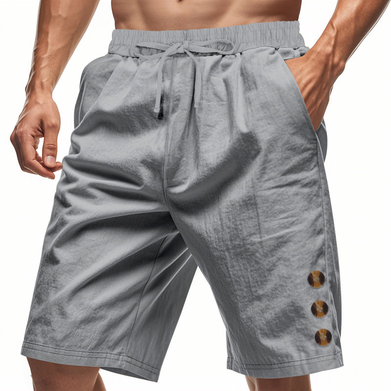 Gray shorts with button details on a white background